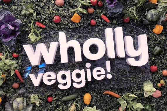 6 foot sign reading "Wholly Veggie!" at entrance to Montreal Vegan Festival