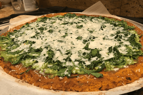 Plated and ready: Uncle Dom's Sweet Potato Pizza with avocado, spinach, and vegan cheese.