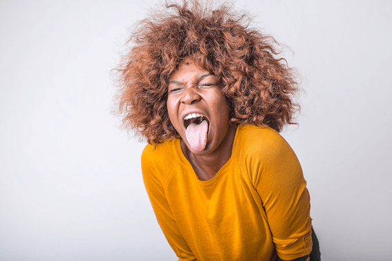 Woman making a disgusted face, presumably at a hamburger.